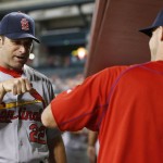 St. Louis Cardinals manager Mike Matheny, left, gives Eric Fryer a fist pump in the dugout prior to a baseball game against the Arizona Diamondbacks Monday, April 25, 2016, in Phoenix. (AP Photo/Ross D. Franklin)