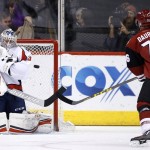 Washington Capitals' Philipp Grubauer (31), of Germany, makes a save on a shot by Arizona Coyotes' Laurent Dauphin (76) during the first period of an NHL hockey game Saturday, April 2, 2016, in Glendale, Ariz. (AP Photo/Ross D. Franklin)