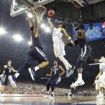 North Carolina guard Joel Berry II (2) shoots as Villanova guard Phil Booth (5) defends during the second half of the NCAA Final Four tournament college basketball championship game Monday, April 4, 2016, in Houston. (AP Photo/David J. Phillip)