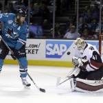 Arizona Coyotes goalie Mike Smith (41) stops a shot in front of San Jose Sharks' Joe Thornton (19) during the first period of an NHL hockey game Saturday, April 9, 2016, in San Jose, Calif. (AP Photo/Marcio Jose Sanchez)