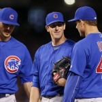 Chicago Cubs pitcher Kyle Hendricks, middle, smiles as he talks with Anthony Rizzo (44) and Kris Bryant, left, during the seventh inning of a baseball game against the Arizona Diamondbacks on Saturday, April 9, 2016, in Phoenix. The Cubs defeated the Diamondbacks 4-2. (AP Photo/Ross D. Franklin)