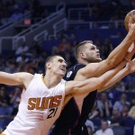 Los Angeles Clippers' Cole Aldrich, right, grabs a rebound in front of Phoenix Suns' Alex Len (21) during the first half of an NBA basketball game Wednesday, April 13, 2016, in Phoenix. (AP Photo/Ross D. Franklin)
