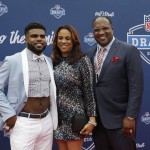 Ohio State's Ezekiel Elliott, left, poses for photos upon arriving for the first round of the 2016 NFL football draft at the Auditorium Theater of Roosevelt University, Thursday, April 28, 2016, in Chicago. (AP Photo/Nam Y. Huh)