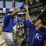 Kansas City Royals' Kendrys Morales, left, celebrates his home run with Mike Moustakas in the dugout during the second inning of a spring training baseball game against the Arizona Diamondbacks Friday, April 1, 2016, in Phoenix. (AP Photo/Jae C. Hong)