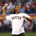 Arizona Cardinals wide receiver Larry Fitzgerald throws out the ceremonial first pitch prior to a baseball game between the Colorado Rockies and the Arizona Diamondbacks, Monday, April 4, 2016, in Phoenix. (AP Photo/Matt York)