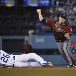 Arizona Diamondbacks shortstop Nick Ahmed, right, throws to first base after he forced out Los Angeles Dodgers' Chase Utley, left, at second during the fifth inning of a baseball game in Los Angeles, Wednesday, April 13, 2016. Cprey Seager was safe at first. (AP Photo/Kelvin Kuo)
