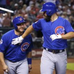 Chicago Cubs Jake Arrieta, right, greets teammate Miguel Montero at the plate after hitting a two-run home run against the Arizona Diamondbacks during the second inning of a baseball game, Sunday, April 10, 2016, in Phoenix. (AP Photo/Matt York)