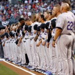 The Colorado Rockies line up during the National Anthem prior to a baseball game against the Arizona Diamondbacks, Monday, April 4, 2016, in Phoenix. (AP Photo/Matt York)
