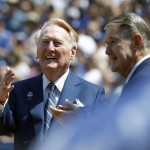 Los Angeles Dodgers broadcaster Vin Scully, left, looks up in the stands with former owner Peter O'Malley as Scully is honored before the start of an opening day baseball game against the Arizona Diamondbacks in Los Angeles, Tuesday, April 12, 2016. (AP Photo/Alex Gallardo)