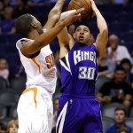 Sacramento Kings guard Seth Curry (30) shoots over Phoenix Suns guard Ronnie Price during the first half of an NBA basketball game, Monday, April 11, 2016, in Phoenix. (AP Photo/Matt York)