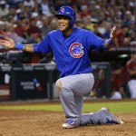 Chicago Cubs Addison Russell reacts after scoring on a base hit by Jason Heyward during the eighth inning of a baseball game against the Arizona Diamondbacks, Sunday, April 10, 2016, in Phoenix. (AP Photo/Matt York)