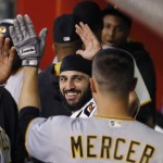 Pittsburgh Pirates' Jordy Mercer, right, celebrates his home run against the Arizona Diamondbacks with a smiling Sean Rodriguez, middle, during the third inning of a baseball game Friday, April 22, 2016, in Phoenix. (AP Photo/Ross D. Franklin)