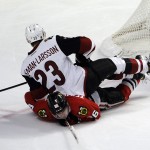 Arizona Coyotes defenseman Oliver Ekman-Larsson (23) sits on top of Chicago Blackhawks left wing Teuvo Teravainen (86) in the third period of an NHL hockey game Tuesday, April 5, 2016, in Chicago. The Blackhawks won 6-2. (AP Photo/David Banks)