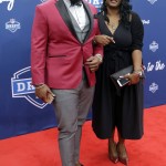 Alabama's A'Shawn Robinson, left, poses for photos upon arriving for the first round of the 2016 NFL football draft at the Auditorium Theater of Roosevelt University, Thursday, April 28, 2016, in Chicago. (AP Photo/Nam Y. Huh)