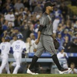 Arizona Diamondbacks relief pitcher Randall Delgado returns to the mound after giving up an RBI double to Los Angeles Dodgers' Enrique Hernandez during seventh inning of a baseball game in Los Angeles, Thursday, April 14, 2016. (AP Photo/Chris Carlson)