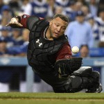 Arizona Diamondbacks catcher Welington Castillo is unable to make a catch on an infield fly hit by Los Angeles Dodgers' Yasmani Grandal during the eighth inning of a baseball game in Los Angeles, Wednesday, April 13, 2016. Grandal reached on the error. (AP Photo/Kelvin Kuo)
