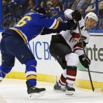 Arizona Coyotes' Antoine Vermette, right, is checked off the puck by St. Louis Blues' Paul Stastny during the first period of an NHL hockey game Monday, April 4, 2016, in St. Louis. (AP Photo/Billy Hurst)