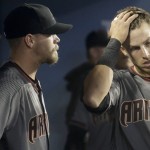 Arizona Diamondbacks relief pitcher Andrew Chafin, left, and third baseman Jake Lamb react in the dugout after the Diamondbacks gave up five runs during seventh inning of a baseball game against the Los Angeles Dodgers in Los Angeles, Thursday, April 14, 2016. (AP Photo/Chris Carlson)
