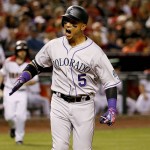Colorado Rockies right fielder Carlos Gonzalez (5) crosses the plate after hitting a solo home run against the Arizona Diamondbacks during the third inning of a baseball game, Monday, April 4, 2016, in Phoenix. (AP Photo/Matt York)