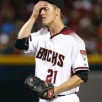Arizona Diamondbacks starting pitcher Zack Greinke (21) reacts to giving up a home run against the Colorado Rockies during the fourth inning of a baseball game, Monday, April 4, 2016, in Phoenix. (AP Photo/Matt York)