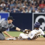 San Diego Padres' Alexei Ramirez slides into second as Arizona Diamondbacks shortstop Nick Ahmed applies a tag during the ninth inning of a baseball game Saturday, April 16, 2016, in San Diego. Ramirez was originally called safe but the call was reversed on appeal. (AP Photo/Lenny Ignelzi)