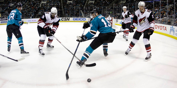 San Jose Sharks' Nick Spaling (16) reaches for the puck next to Arizona Coyotes' Anthony Duclair (1...
