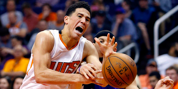 Phoenix Suns guard Devin Booker (1) has the ball knocked away by Sacramento Kings guard Seth Curry ...