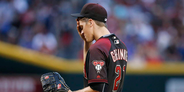11 / 18

Arizona Diamondbacks' Zack Greinke wipes his forehead after giving up a run to the Chicago...