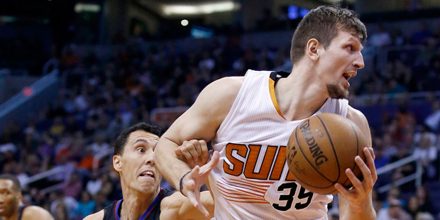 Phoenix Suns' Mirza Teletovic (35) spins past Los Angeles Clippers' Pablo Prigioni, middle, as Clip...