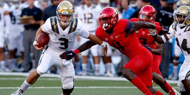 UCLA quarterback Josh Rosen (3) gets away from Arizona safety Will Parks during the first half of a...