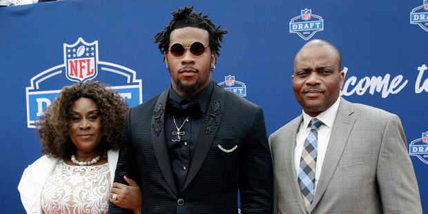 Mississippi's Robert Nkemdiche, center, poses for photos upon arriving for the first round of the 2...