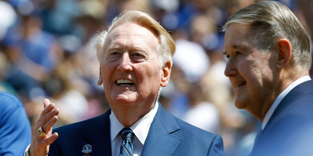 Los Angeles Dodgers broadcaster Vin Scully, left, looks up in the stands with former owner Peter O'...