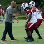 Inside linebackers coach Larry Foote instructs Markus Golden (44) and Kareem Martin (96) during Arizona Cardinals OTAs Tuesday, May 17. (Photo by Adam Green/Arizona Sports)