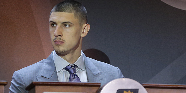 Phoenix Suns player Alex Len listens for the Suns position in the NBA Draft during the 2015 NBA dra...