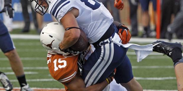 Texas cornerback Bryson Echols (15) tackles BYU receiver Mitchell Juergens (87) during the first qu...