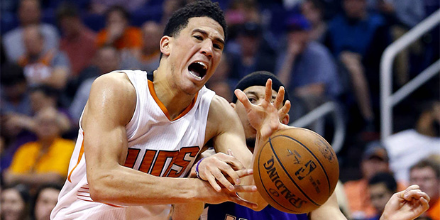 Phoenix Suns guard Devin Booker (1) has the ball knocked away by Sacramento Kings guard Seth Curry ...