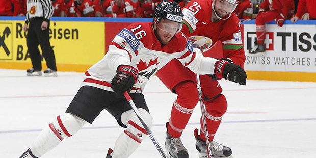 Oleg Yevenko of Belarus, right, fights for the puck with Canada’s Max  Domi  during the Hockey Wo...