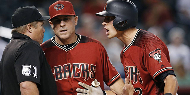 Arizona Diamondbacks' Nick Ahmed, right, argues a called third strike after being ejected by umpire...