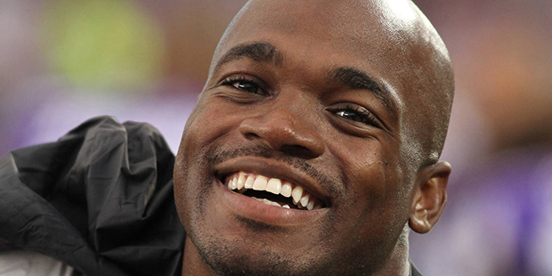 FILE - In this Aug. 22, 2015, file photo, Minnesota Vikings running back Adrian Peterson smiles on ...