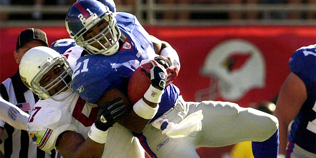 New York Giants' Tiki Barber, top, is thrown down by Arizona Cardinals' Ronald McKinnon during the ...