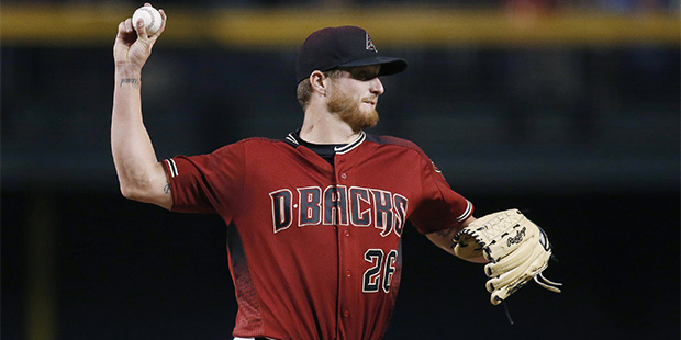 Arizona Diamondbacks' Shelby Miller throws to first base during the first inning of a baseball game...