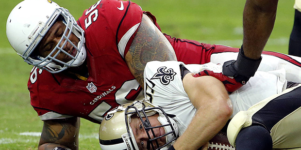 New Orleans Saints quarterback Drew Brees lies on the ground after being sacked by Arizona Cardinal...