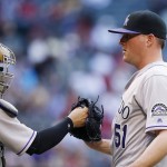 Colorado Rockies' Jake McGee (51) gets a fist pump from catcher Tony Wolters, left, after the final out a baseball game against the Arizona Diamondbacks, Sunday, May 1, 2016, in Phoenix. The Rockies defeated the Diamondbacks 6-3. (AP Photo/Ross D. Franklin)