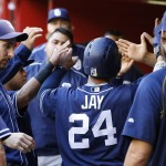 San Diego Padres' Jon Jay (24) celebrates with Adam Rosales, left, and other teammates after he scored against the Arizona Diamondbacks during the first inning of a baseball game Friday, May 27, 2016, in Phoenix. (AP Photo/Ross D. Franklin)