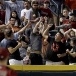 Fans catch a solo home run ball hit by San Francisco Giants' Trevor Brown during the third inning of a baseball game against the Arizona Diamondbacks, Sunday, May 15, 2016, in Phoenix. (AP Photo/Matt York)