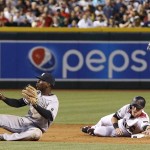 Arizona Diamondbacks' Jake Lamb, bottom right, reaches second base safely as New York Yankees' Didi Gregorius, left, was unable to make the play on the force out even as Yankees' Starlin Castro, back right, disapproves of the call during the third inning of a baseball game, Monday, May 16, 2016, in Phoenix. (AP Photo/Ross D. Franklin)