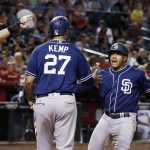 San Diego Padres' Yangervis Solarte, right, celebrates his three-run home run against the Arizona Diamondbacks with Matt Kemp (27) and Wil Myers, left, during the sixth inning of a baseball game Friday, May 27, 2016, in Phoenix. (AP Photo/Ross D. Franklin)