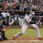 San Francisco Giants' Johnny Cueto, right, pops up a bunt as Arizona Diamondbacks' Welington Castillo, left, watches during the third inning of a baseball game Thursday, May 12, 2016, in Phoenix. Cueto managed to move Gregor Blanco over to second base to earn a sacrifice on the play. (AP Photo/Ross D. Franklin)