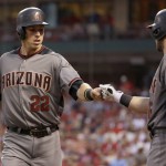 Arizona Diamondbacks' Jake Lamb, left, is congratulated by teammate Chris Owings after scoring during the first inning of a baseball game against the St. Louis Cardinals Friday, May 20, 2016, in St. Louis. (AP Photo/Jeff Roberson)