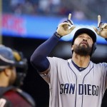 San Diego Padres' Matt Kemp points to the sky after hitting a home run as Arizona Diamondbacks' Welington Castillo, left, watches during the first inning of a baseball game Saturday, May 28, 2016, in Phoenix. (AP Photo/Ross D. Franklin)